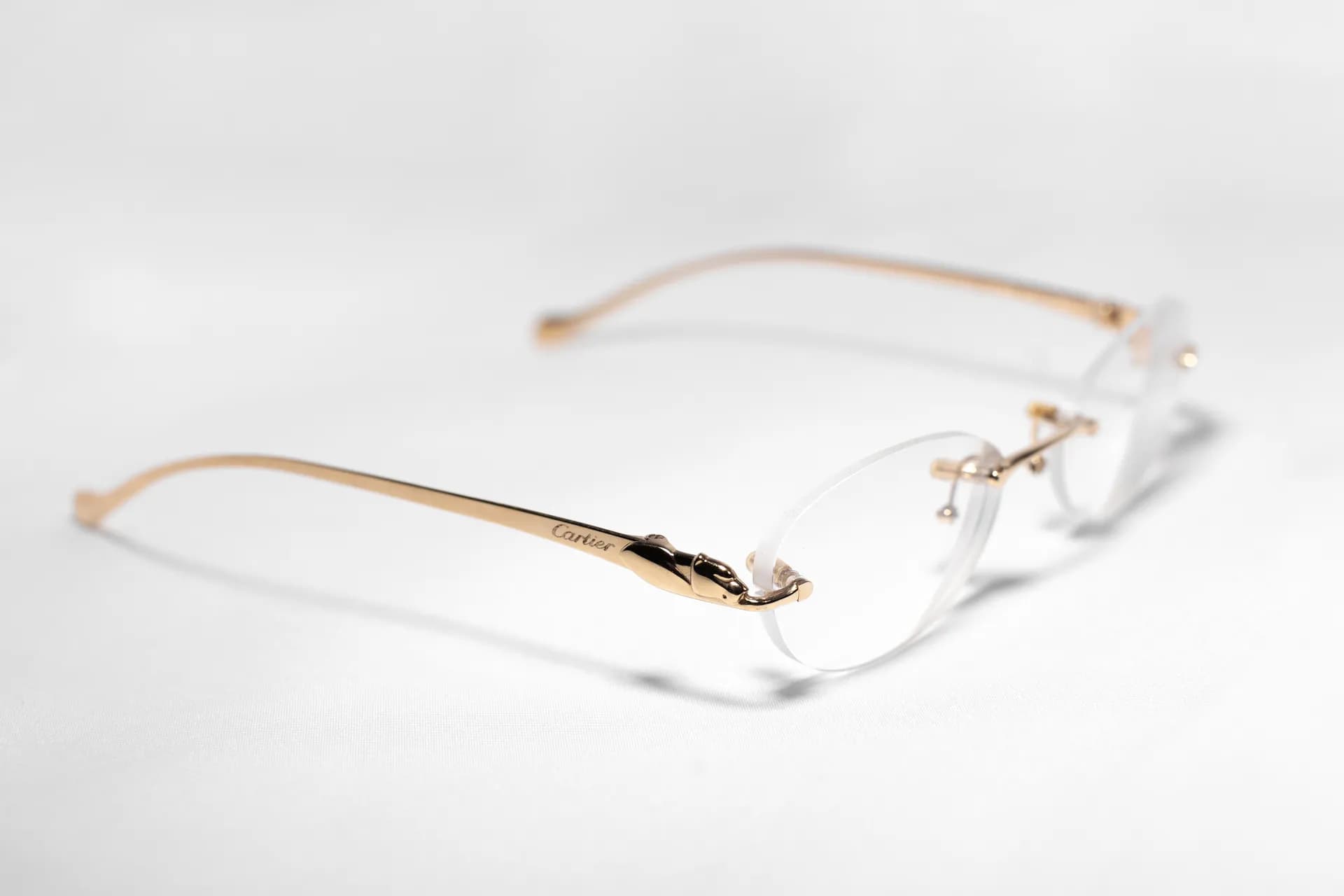 Gold rimless frame in a bright editorial setup
